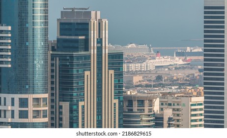 Skyscrapers Of Dubai With A Lot Of Ships In Port Behind Aerial Timelapse. Office Buildings In Financial District Close Up View