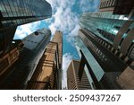 Skyscrapers reaching towards the sky in central Hong Kong on a sunny day with scattered clouds