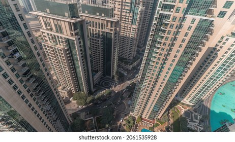 Skyscrapers Skyline Look Down Perspective In Dubai Downtown With Shadows Moving Fast Aerial Timelapse. Modern Towers With Traffic On The Road Between Buildings