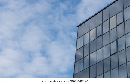 Skyscrapper Building On A Blue Sky Background With Steel And Glass