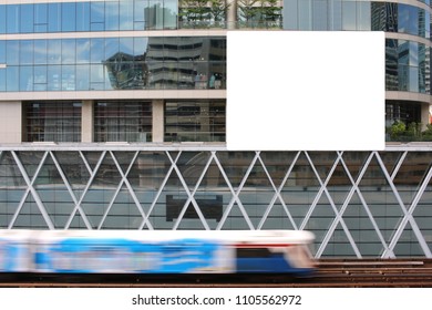 Skytrain running through the building, which has a banner stuck.
