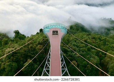 Skywalk Betong Famous landmark in Yala southern thailand. Fog misty in the morning with green nature hill mountain valley.