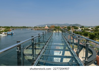 Skywalk Observation Deck made by transparent glass with beautiful Kanchanaburi city view by river in summer, Thailand.