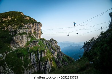 Slackliners during a session of highline at Cima Caldoline Highline Festival 2021  - Powered by Shutterstock