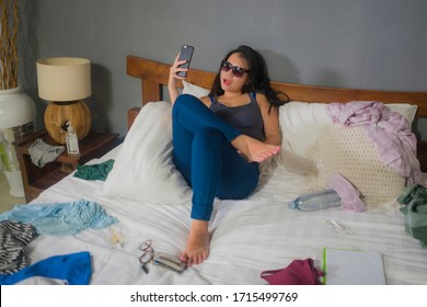 Slackness And Chaos At Home Lockdown - Young Disorderly And Chaotic Asian Korean Woman On Bed Taking Selfie With Mobile Phone On Grimy And Messy Bedroom In Social Media Addiction