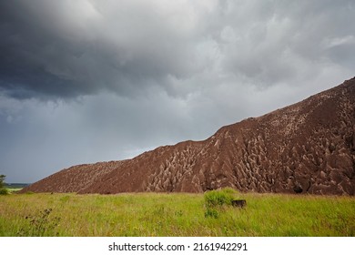 Slag From Waste Rocks From Clay And Sand. Industrial Mountain Against The Backdrop Of Nature And Blue Sky