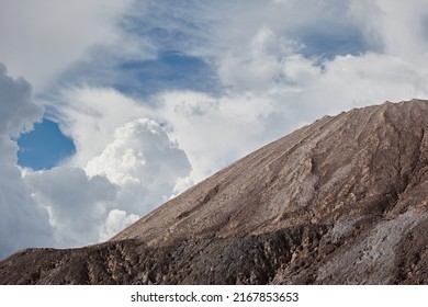 Slag From Waste Rocks From Clay And Sand. Industrial Mountain Against The Backdrop Of Nature And Blue Sky