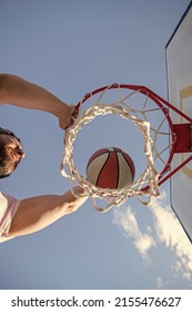 slam dunk in motion. top view. summer activity. man with basketball ball on court.