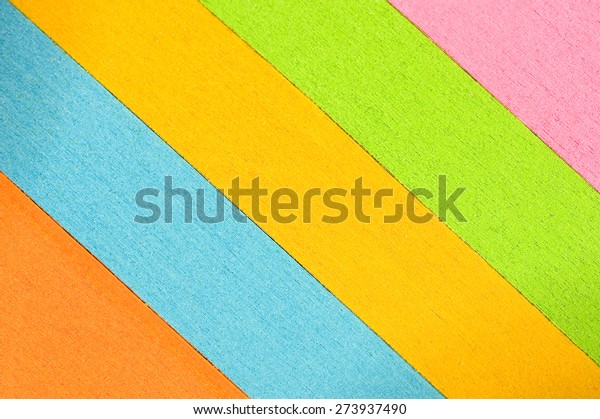 Slanted multi-colored stacks of paper as\
background/ Slanted Colored Paper\
Background