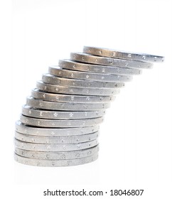 A slanting stack of coins isolated on a white background