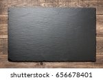 Slate blackboard on wooden background