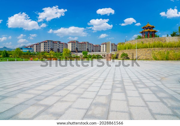 The slate pavement is the prospect of the park\
scenery, the background is bamboo forest walls and residential\
buildings bridge buildings