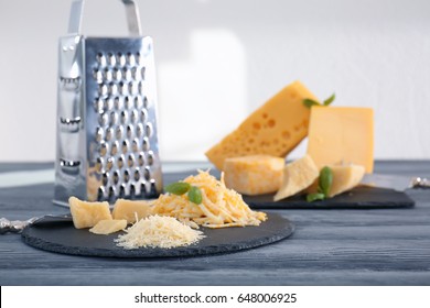 Slate plate with different grated cheese on table - Powered by Shutterstock