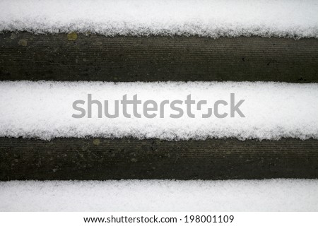 Slate roof covered with thawing snow