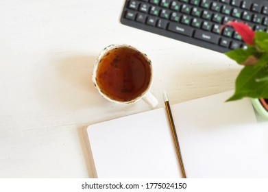 A Slave To The Desk Top, Keyboard, Notepad, Pen, Cup Of Tea.