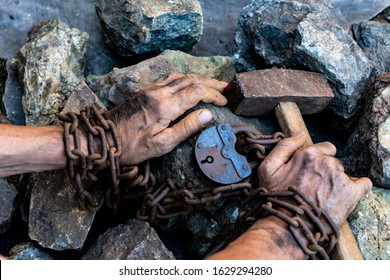 Slave Hard Work. Penal Servitude. Slave Chain Tied Hands Hold A Hammer. The Desire To Free Oneself. The Desire To Break The Shackles.