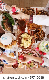 Slavic Family At The Festive Easter Table With Snacks