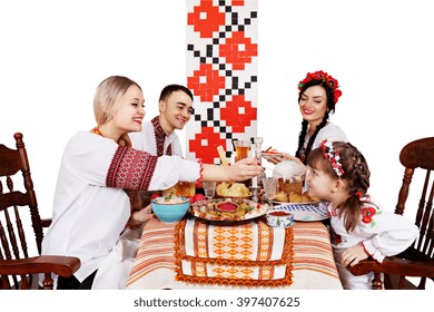 Slavic Family At The Festive Easter Table With Snacks