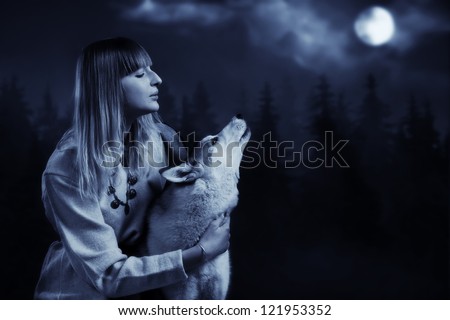 Slavonian girl in the traditional suit and gey wolf in the deep forest