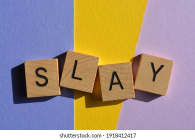 Slay, teen slang meaning someone looks amazing or did something very well. Word in wooden alphabet letters isolated on colorful background. 