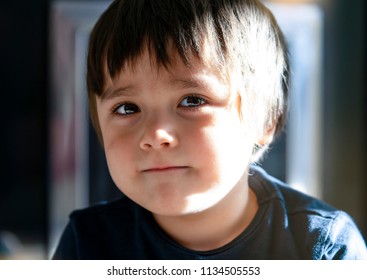 Slective Focus Of Adorable Boy Smiling Face With Sunny Light Shining Behind, Preschool Boy With A Happy Face, Portrait Of Cute Little Boy With A Bit Of Smile Looking At Camera With Beautiful Eyes