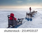 Sled dog-racing with Alaskan malamute and husky dogs. Snow, winter, competition, race concept. Husky dog sledding in winter Baikal, Siberia.