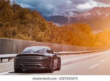 Sleek Black German Roadster. Brand New Luxury Carrera Sports Car on the Highway. Aerodynamic beast on the autobahn in Germany. - Shutterstock ID 2327651673