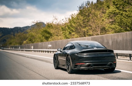 Sleek Black German Roadster. Brand New Luxury Carrera Sports Car on the Highway. Rear view of the 911 GTS sports car. - Shutterstock ID 2337568973