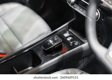 sleek center console displaying an automatic gear selector, start-stop button, and AC controls, showcasing user-friendly design and convenience.