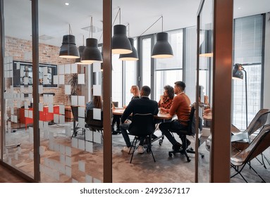 In a sleek glass office space, a team of business professionals engage in lively discussions and exchange strategic ideas, showcasing collaboration and innovation at the heart of modern corporate - Powered by Shutterstock