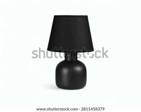 Sleek matte black table lamp with fabric shade against a white background.