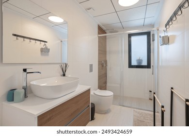 A sleek, modern bathroom featuring a glass-enclosed shower, a vessel sink, wooden cabinetry, and contemporary fixtures for a clean look. - Powered by Shutterstock