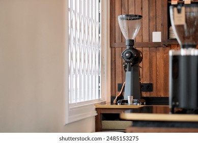 Sleek Modern Coffee Grinder on Wooden Counter in Bright Cozy Café Corner for Perfect Brew - Powered by Shutterstock