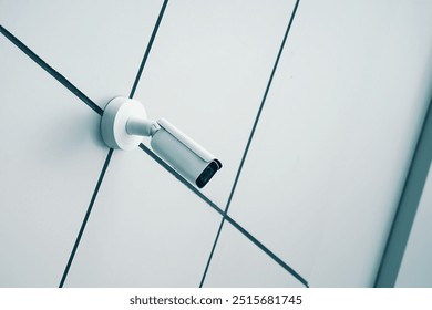 A sleek and modern security camera is securely mounted on a minimalist wall, ensuring safety and effective surveillance - Powered by Shutterstock