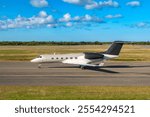 A sleek private jet is taxiing on the runway of Punta Cana airport.