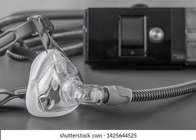 Sleep Apnea CPAP Mask On The Grey Table