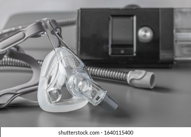 Sleep Apnea CPAP Mask On The Grey Table