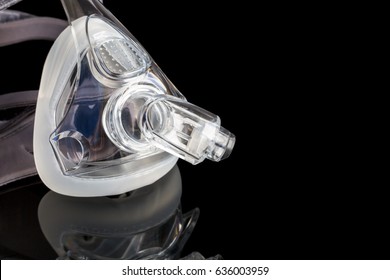 Sleep Apnea CPAP Mask On The Black Background