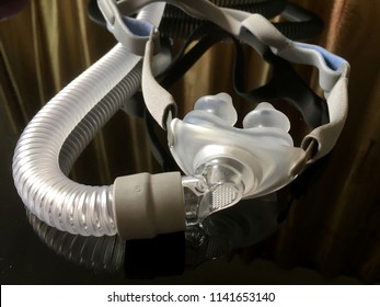 Sleep apnea CPAP Pillow mask and hose on the black table background - for people with sleep apnea, respiratory, or breathing disorder