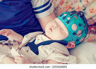 A sleep child EEG is a recording. Electrical activity of the brain. Study of a sleeping baby. Diagnosis of diseases and disorders. Children's health.
