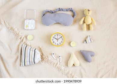 Sleep Concept With Accessories. Flat Lay Composition With Sleep Eye Mask,  Alarm Clock, Scented Candles. Healthy Night Sleep, Good Sleep, Night Time Routine. Top View 