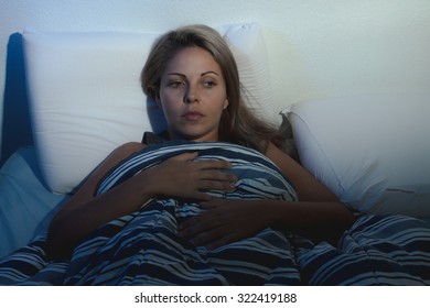 Sleep Disorder, Insomnia. Young Blonde Woman Lying On The Bed Awake