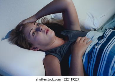 Sleep Disorder, Insomnia. Young Blonde Woman Lying On The Bed Awake