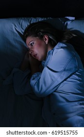 Sleep Disorder, Insomnia. Young Blonde Woman Lying On The Bed Awake