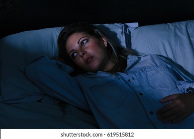 Sleep Disorder, Insomnia. Young Blonde Woman Lying On The Bed Awake