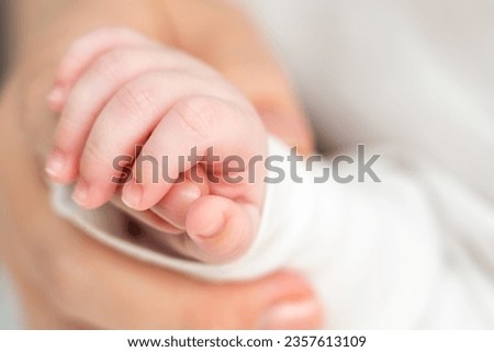 In sleep, newborn clings to maternal warmth. Concept of unbreakable bonds formed early