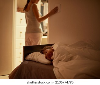 Sleep Tight My Boy. Shot Of A Mother Turning Off The Light As Her Son Sleeps Peacefully In Bed.