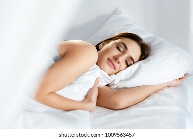 Sleep. Young Woman Sleeping In Bed. Portrait Of Beautiful Female Resting On Comfortable Bed With Pillows In White Bedding In Light Bedroom In Morning. People Sleep. High Quality Image. - Powered by Shutterstock