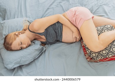 Sleep-deprived pregnant woman struggles with insomnia, navigating the challenges of restlessness during pregnancy - Powered by Shutterstock