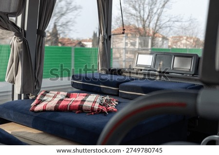 Sleeper bus interior with lie flat passenger seats pillows and blanket for comfortable long distance travel